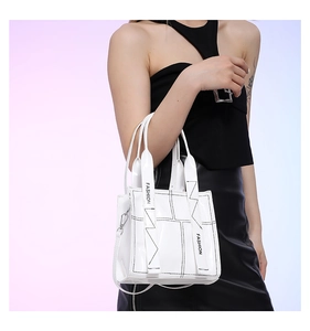 Detail der weißen PU-Ledertasche mit schwarzen Linien und FASHION-Schriftzug am Gurt