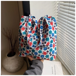Floral canvas tote bag with Hey Sunday print and double handles in soft natural light