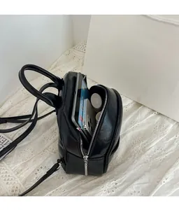 Interior view showing large capacity of black PU leather mini backpack for tablets