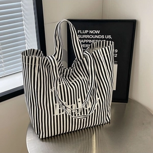 Fashionable black and white striped canvas tote bag with white Enjoy typography