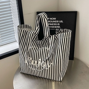 Chic black and white vertical striped canvas tote bag with Enjoy lettering print