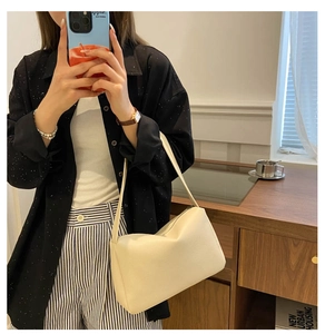 Close-up of cream PU leather shoulder bag featuring elegant litchi grain texture for women