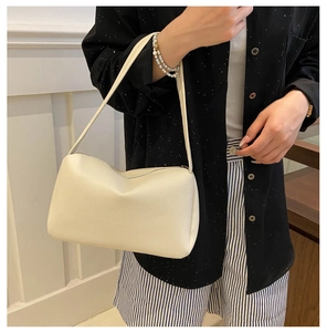 Detailed view of cream PU leather shoulder bag with lychee texture and zipper