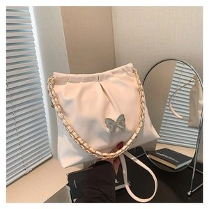 Chic beige PU leather crossbody bag with butterfly detail and elegant pleated design