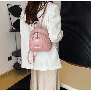 Close-up of pink PU leather mini backpack with textured finish and adjustable straps