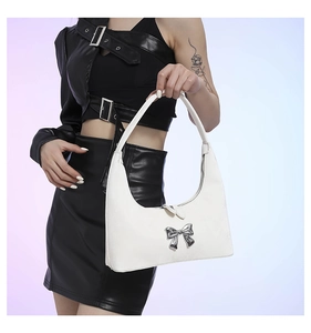 Detailed macro view of white PU leather hobo bag with a silver metallic bow decoration