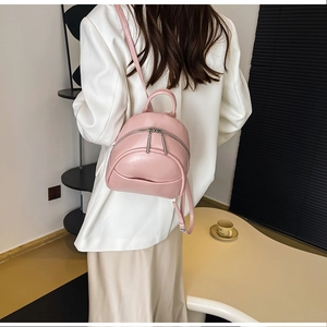 Close-up of pink PU leather mini backpack with silver metal double zippers for women