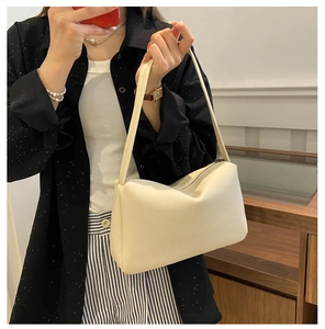 Detailed view of cream-white lychee texture PU leather shoulder bag with top metal zipper