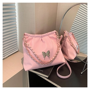 Pink pleated PU leather crossbody bag featuring a silver butterfly charm and chain strap
