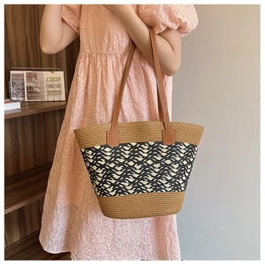 Detail view of woven tote bag showing geometric texture and leather shoulder straps