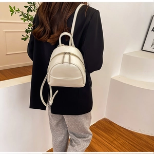 Detail view of mini cream PU leather backpack with double zippers and top handle