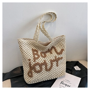 Chic beige woven crochet handbag with dark brown 'bon jour' text on leather garment