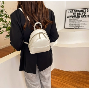 White glossy PU leather mini backpack shown on model to display size and style