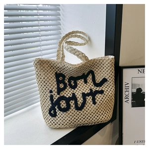 Chic woven straw handbag with black Bonjour embroidery and thick braided handles
