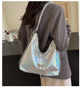 Close-up of holographic silver hobo bag with metal butterfly and chain strap detail