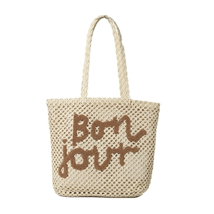 Minimalist woven straw tote bag in cream white featuring brown Bonjour slogan and dual handles