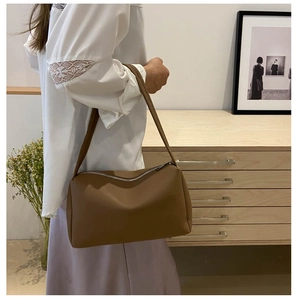 Brown faux leather shoulder bag with lychee texture and silver zipper shown on model