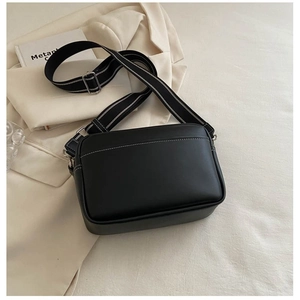 Minimalist black PU leather crossbody camera bag with contrast stitching and striped strap