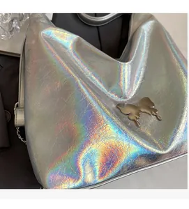 Detail showing holographic silver PU fabric texture and large metal butterfly ornament