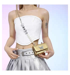 Close-up of golden PU mini bag with butterfly logo and pearl heart-shaped chain