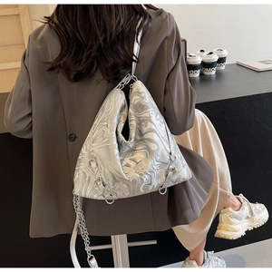 Detailed close-up of a silver marble PU leather tote bag with metal butterfly and chain