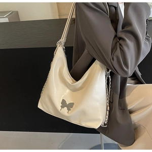 Close-up of cream PU leather shoulder bag featuring silver butterfly metal ornament