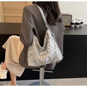 Close-up of stylish silver marble PU leather shoulder bag with butterfly metal buckle