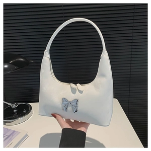 Chic white half-moon PU leather shoulder bag with a silver bow and dual zipper detail
