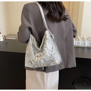 Detail of silver marble PU leather tote bag with metallic chain and butterfly charm
