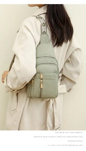 Detail of sage green crossbody bag with lychee texture and floral jacquard strap