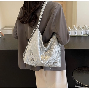 Detail of silver marble texture bag with metal chain strap and butterfly charm