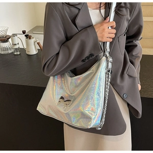 Detail of silver holographic PU leather hobo bag with hollow butterfly metal logo charm