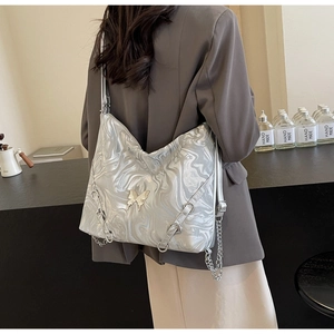 Detail of silver marble PU bag with butterfly charm and metal chain strap