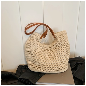 Chic cream straw tote bag with brown leather handles and mesh woven design for summer fashion