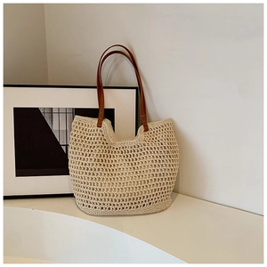 Minimalist beige crochet tote bag with brown leather straps and woven mesh design
