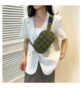 Detail of army green quilted crossbody bag with adjustable strap and buckle closure