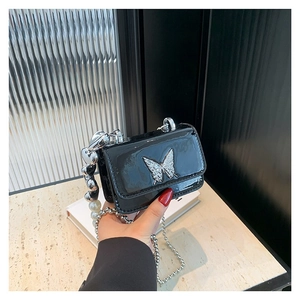 Mini black patent leather crossbody bag with silver butterfly and pearl heart chain strap