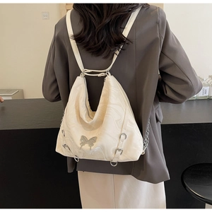 Detail of creamy white PU backpack with marble texture and silver butterfly ornament