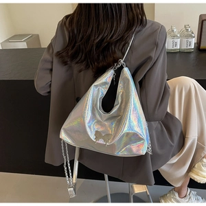 Detail of silver laser PU leather tote bag with metal butterfly buckle and chain strap