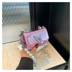 Metallic pink PU crossbody bag with butterfly decor, pearl handle, and heart chains