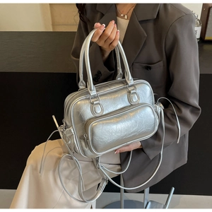 Detail of silver metallic PU Boston bag featuring wrinkled texture and adjustable strap
