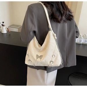 Detail of white marble textured PU shoulder bag with silver butterfly buckle