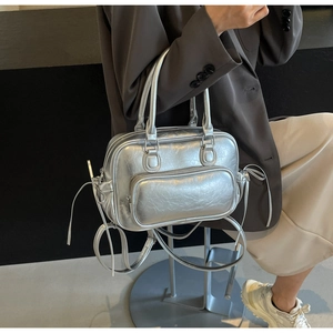 Close-up of metallic silver Boston bag featuring cracked PU leather and multi-pocket details