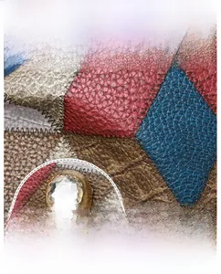 Macro detail of color-block patchwork leather and gold skull clasp with rhinestones
