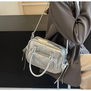 Silver metallic PU leather motorcycle bag with distressed texture and zipper pocket detail