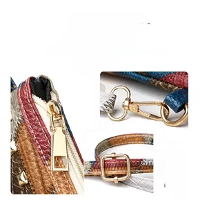 Close-up of multicolor patchwork small square bag with gold metal zippers and hardware