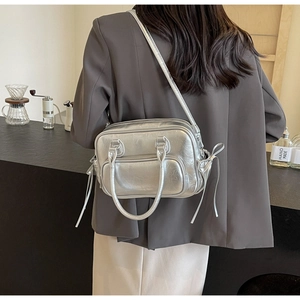 Detail view of silver PU leather bag with metallic finish and side drawstring design