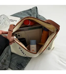 Detailed top view of large canvas tote bag showing spacious interior with brown leather trim