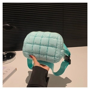 Mint green quilted puffer crossbody bag with adjustable strap and buckle closure