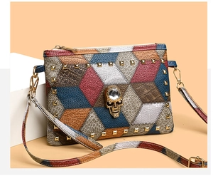 Close-up of patchwork leather texture with golden rivets and crystal skull decoration